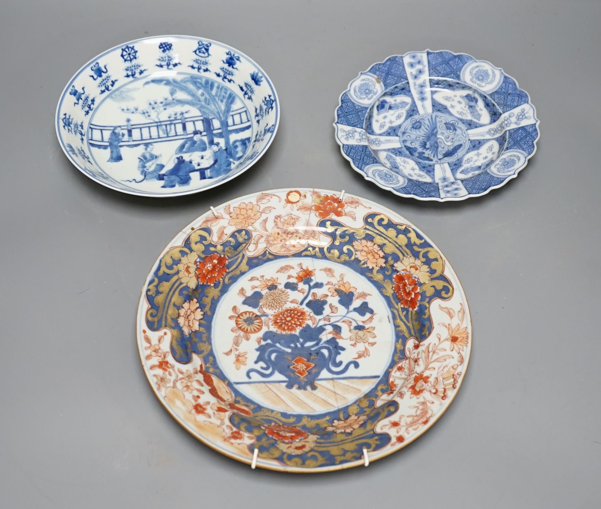 Three Chinese plates including a 19th century Chinese Imari dish, 23cm - repaired, a Chinese famille rose crackleglaze vase, 29cm, together with a famille rose teapot and a crackleglaze celadon ground bottle vase. Talles